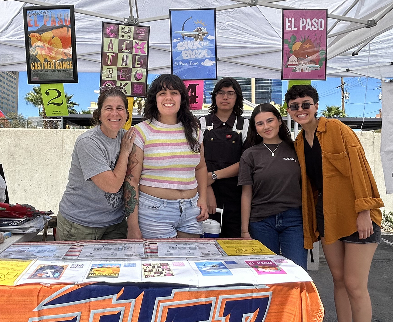 UTEP faculty member Anne M. Giangiulio poses with graphic design students Katrina Estrada, Natalia Olivares Madrilas, Laura Soto-Feliciano and Daniela Villescas at this year's Chalk the Block event. Students sold posters they designed and then brought to life using augmented reality and animation. 