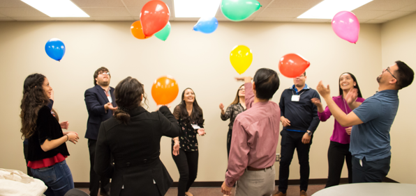 Leadership team celebrating with balloons.